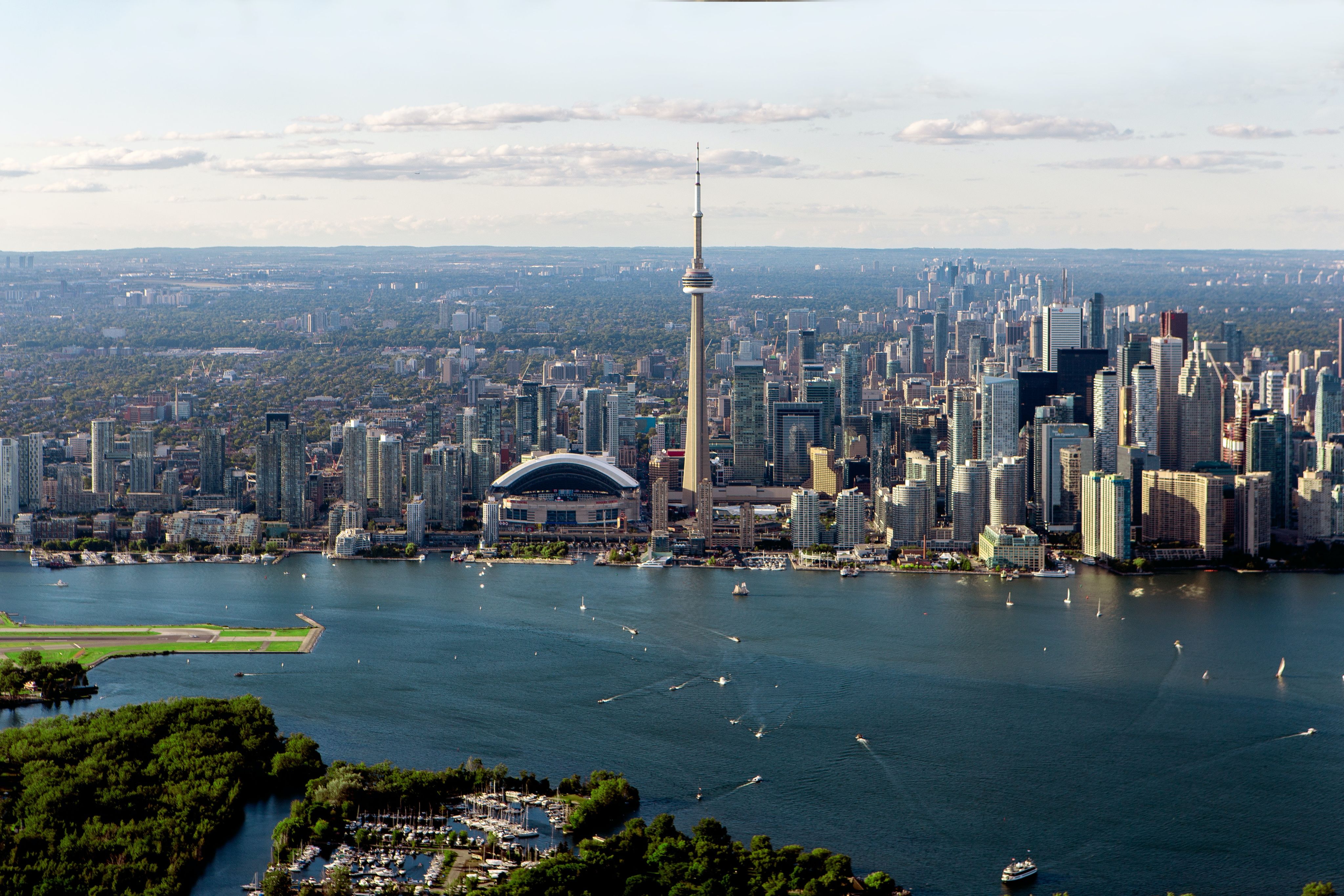 Toronto city skyline with large body of water in the foreground.